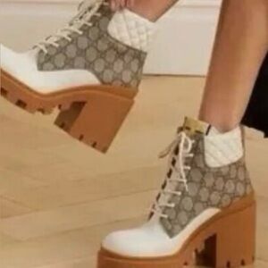 This is a pair of Gucci GG Supreme canvas and leather heeled ankle boots.